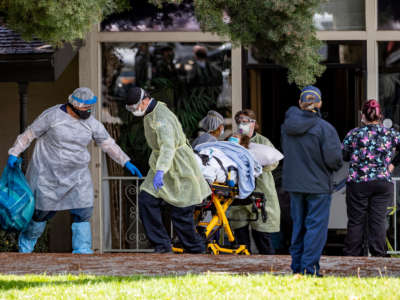 Patients are removed from Magnolia Rehabilitation and Nursing Center after 39 tested positive for coronavirus on April 8, 2020, in Riverside, California.