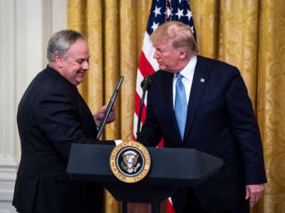 Secretary David Bernhardt, Department of the Interior, shakes President Trump's hand during an event in the East Room at the White House on July 8, 2019, in Washington, D.C.