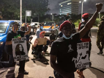 Activists raise their fists in Accra, Ghana, on June 6, 2020, during a protest against the death of George Floyd.