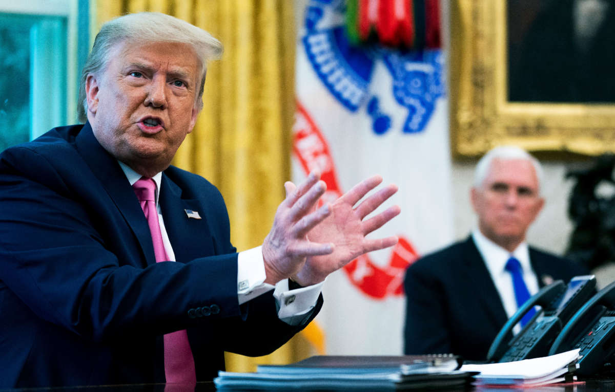 President Trump talks to reporters with Vice President Mike Pence in the Oval Office at the White House, July 20, 2020, in Washington, D.C.