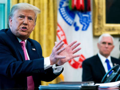 President Trump talks to reporters with Vice President Mike Pence in the Oval Office at the White House, July 20, 2020, in Washington, D.C.