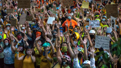 Protesters hold their hands in the air during a Black Lives Matter protest in front of the Multnomah County Justice Center on July 20, 2020, in Portland, Oregon.