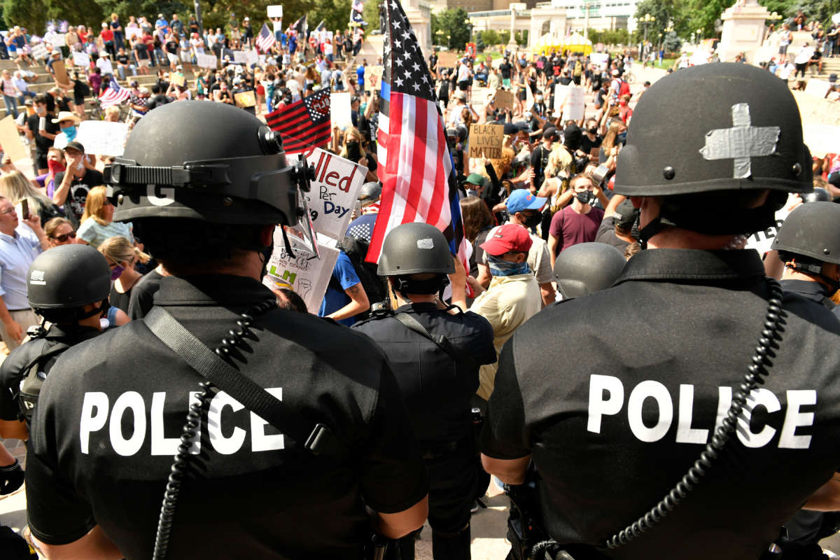 Denver Police officers watch over the crowd at Civic Center Park on July 19, 2020, in Denver, Colorado, where a pro-police rally and counter-protesters gathered.