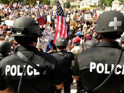 Denver Police officers watch over the crowd at Civic Center Park on July 19, 2020, in Denver, Colorado, where a pro-police rally and counter-protesters gathered.