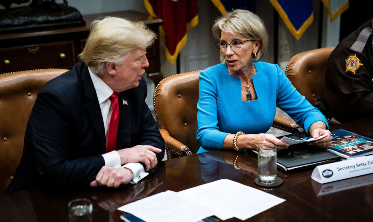 President Trump speaks with Secretary of Education Betsy DeVos in the Roosevelt Room at the White House on December 18, 2018, in Washington, D.C.