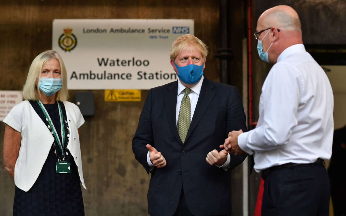 Britain's Prime Minister Boris Johnson wears a face mask during a visit to the headquarters of the London Ambulance Service NHS Trust in London on July 13, 2020.