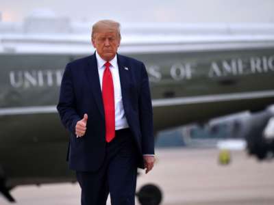 Donald Trump walks away from Air Force One giving the press a very sad thumbs up