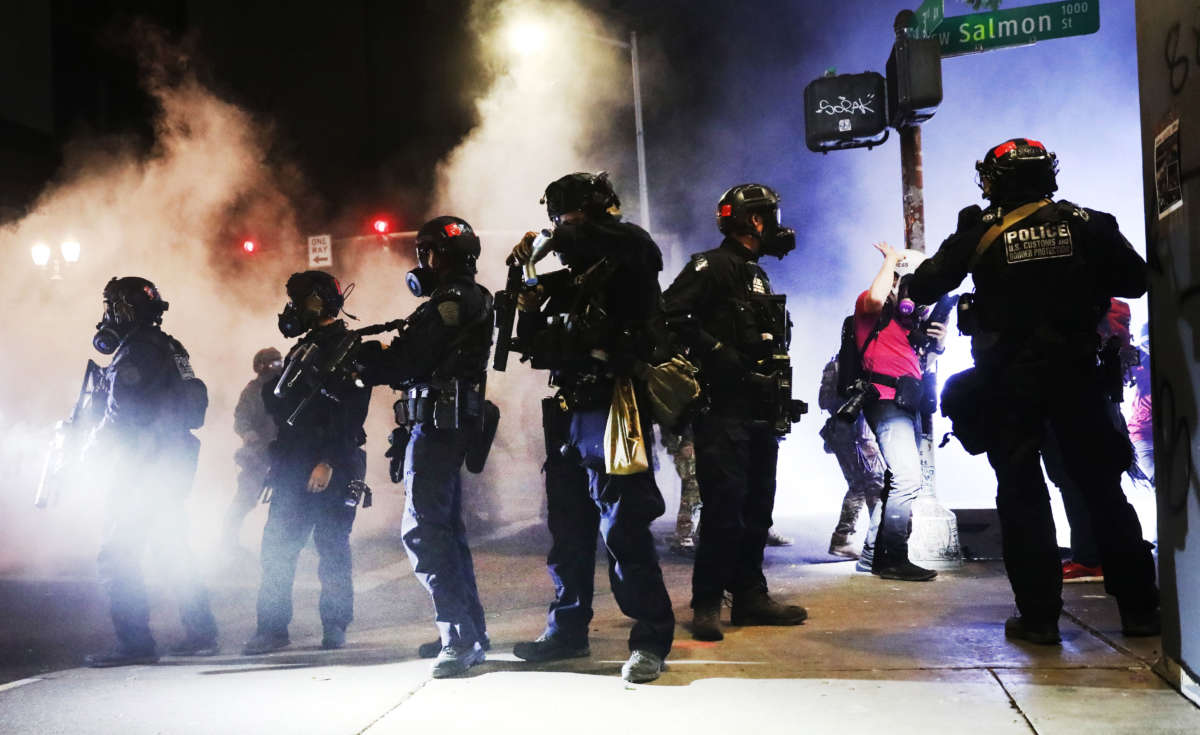 Federal police face off with protesters in front of the Mark O. Hatfield federal courthouse in downtown Portland on July 27, 2020, in Portland, Oregon.