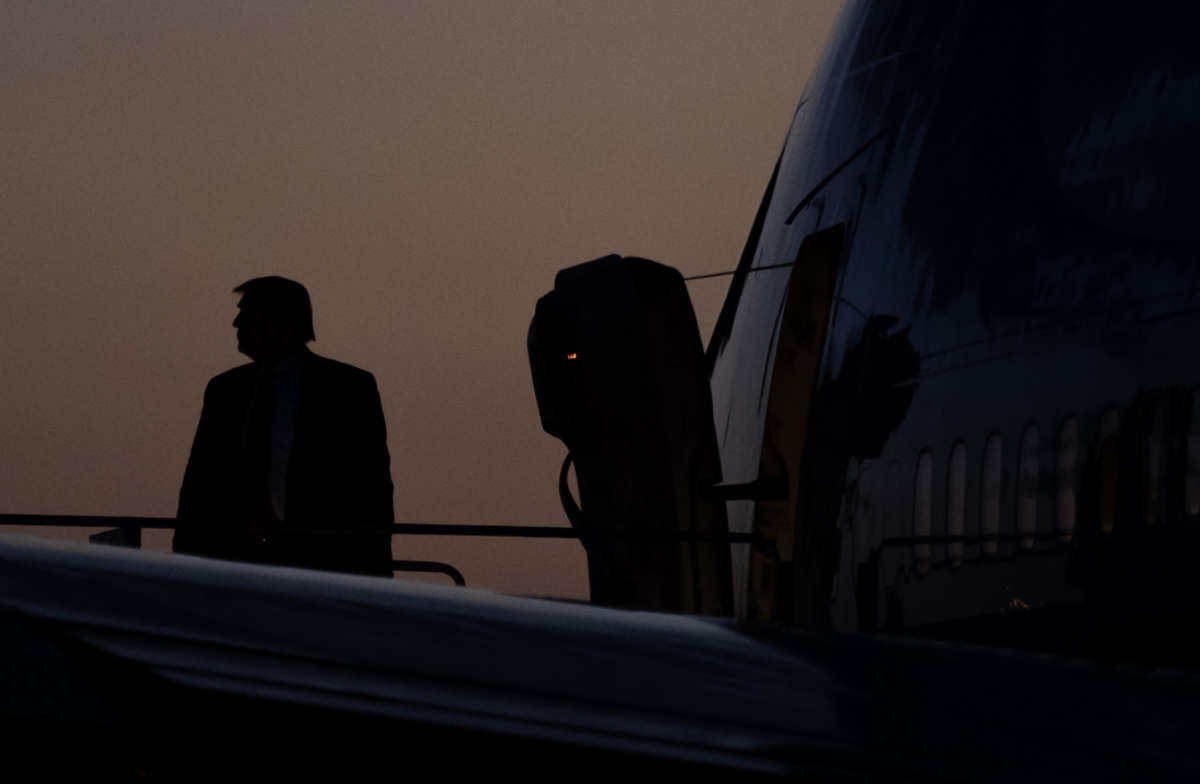 Donald Trump boards Air Force One in ominously stormy conditions