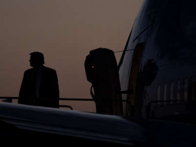 Donald Trump boards Air Force One in ominously stormy conditions