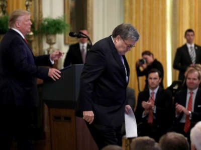 Donald Trump prepares to speaks as Attorney General William Barr departs the stage during a White House ceremony September 9, 2019, in Washington, D.C.