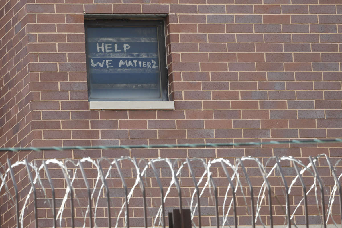 The words "help we matter 2" are seen written in a window at the Cook County Department of Corrections, housing one of the nation's largest jails, in Chicago, Illinois, on April 9, 2020.