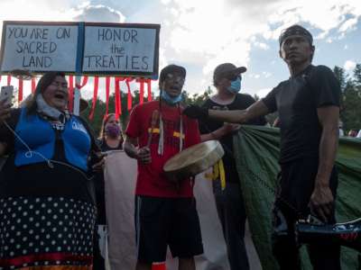 Activists and members of different tribes from the region block the road to Mount Rushmore National Monument as they protest in Keystone, South Dakota, on July 3, 2020, during a demonstration around the Mount Rushmore National Monument and the visit of Donald Trump.