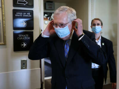 Senate Majority Leader Mitch McConnell replaces his face mask as he leaves a news conference at the U.S. Capitol, on June 17, 2020, in Washington, D.C.