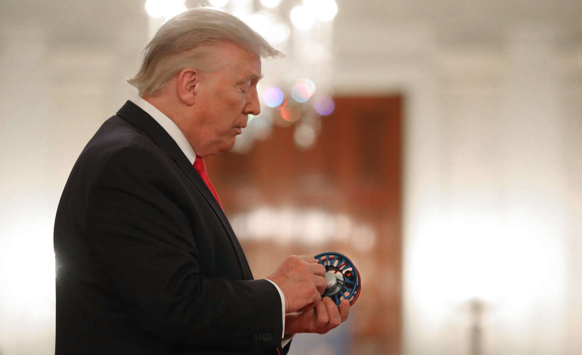 President Donald Trump inspects merchandise while looking at exhibits during a Spirit of America Showcase in the Entrance Hall of the White House July 2, 2020, in Washington, D.C.