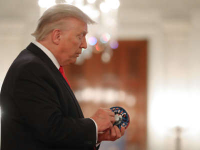 President Donald Trump inspects merchandise while looking at exhibits during a Spirit of America Showcase in the Entrance Hall of the White House July 2, 2020, in Washington, D.C.