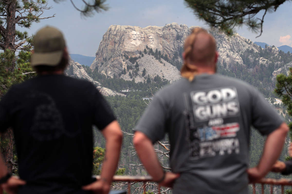 Visitors look at Mount Rushmore National Monument on July 2, 2020, near Keystone, South Dakota.