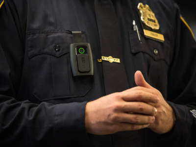 A New York Police Department (NYPD) officer wears a body camera during a media press conference.
