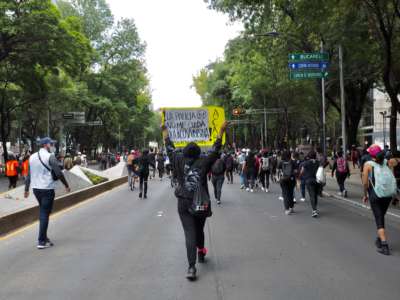 Protesters march down a street