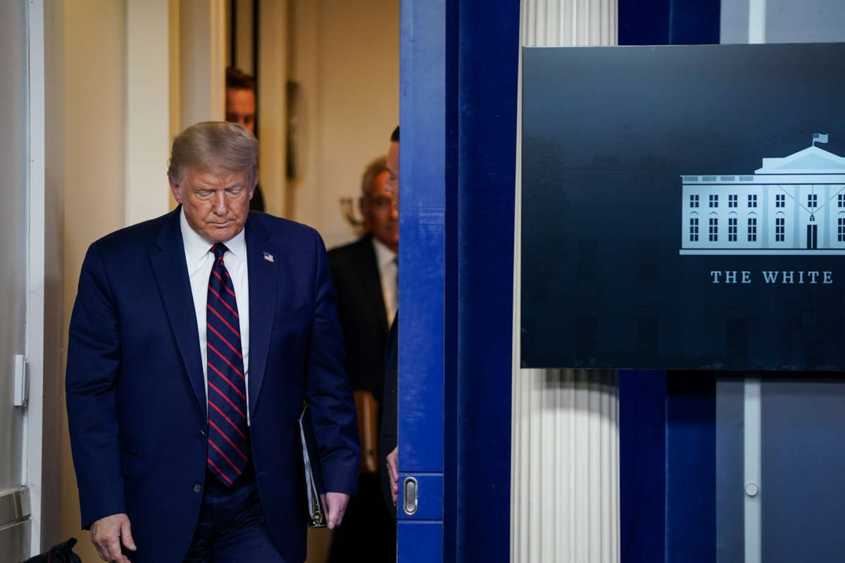 Donald Trump enters the press briefing room