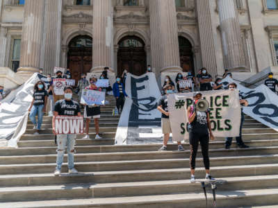 Protesters demand the removal of police officers from schools during a demonstration on the steps of the Department of Education, New York City, on June 25, 2020.