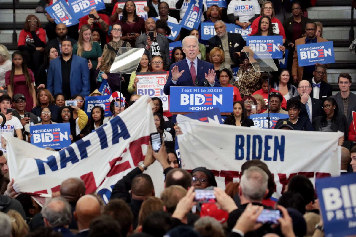 Joe Biden tries to quell activists displaying signs at his campaign event