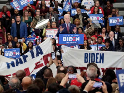Joe Biden tries to quell activists displaying signs at his campaign event