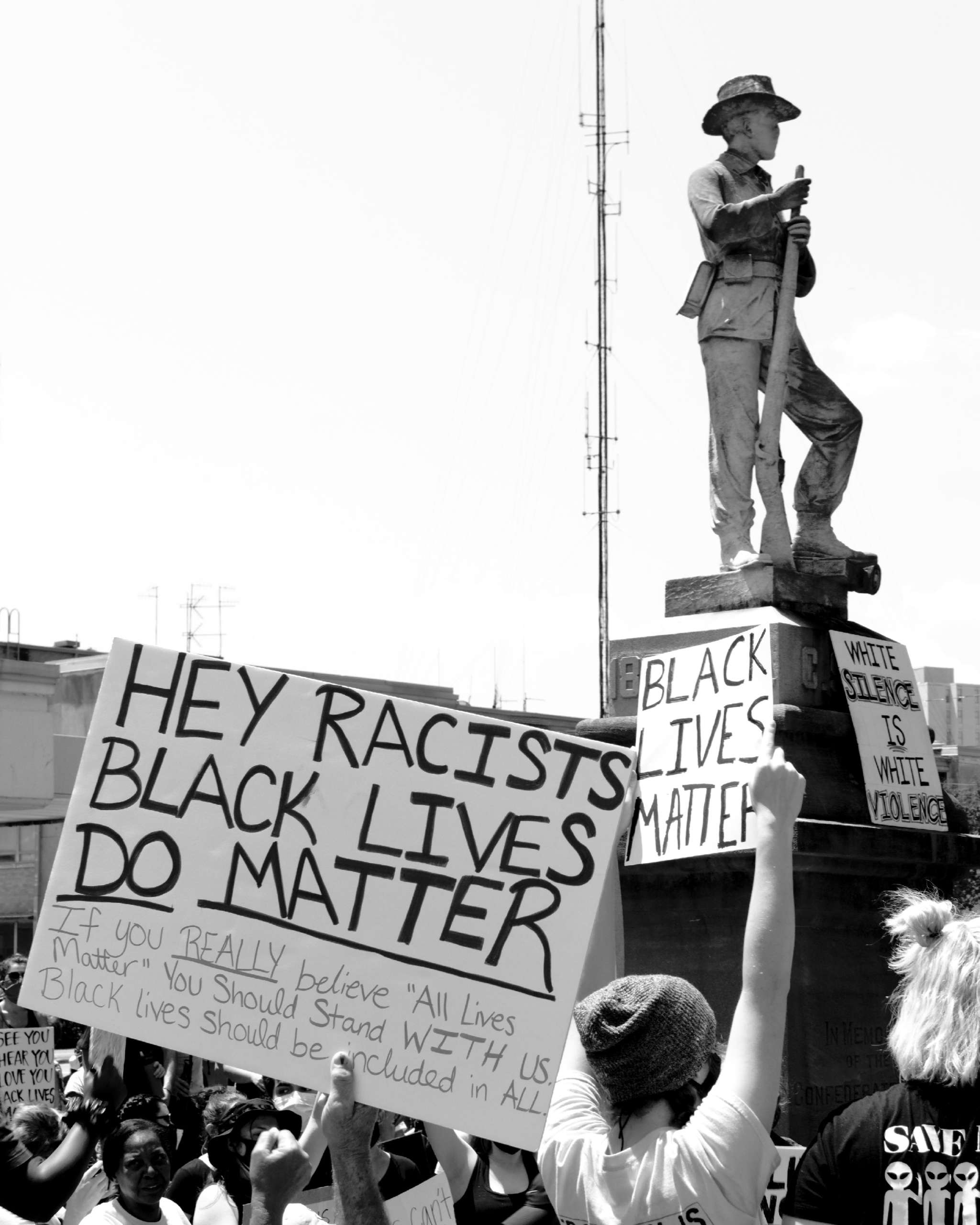 Protesters surround a Confederate monument located at the courthouse of Florence, Alabama, during a protest, on June 7, 2020. This monument marks a once-popular slave market.