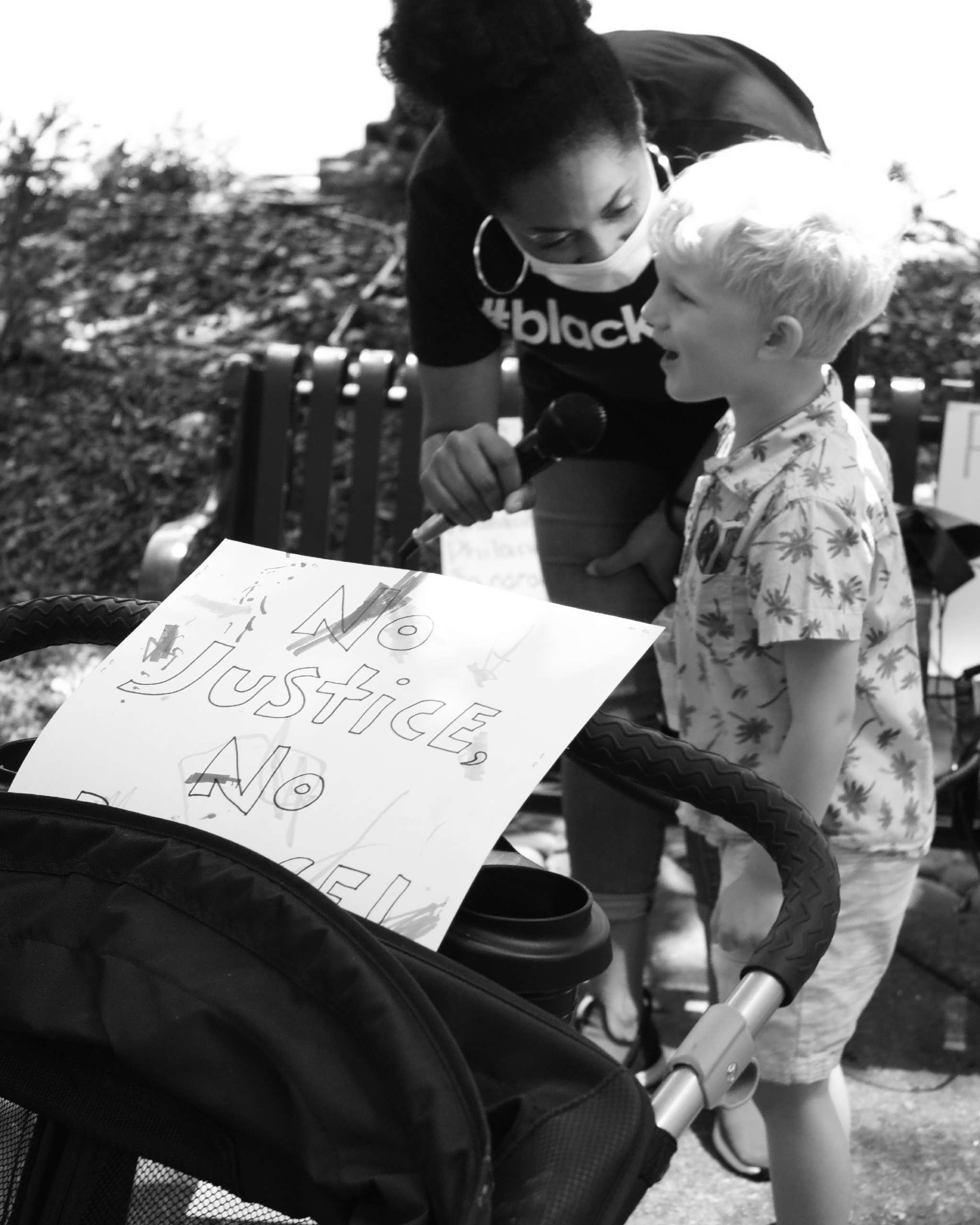 Camille Bennett, founder of Project Say Something, gives the microphone to a child who wished to speak out against racism on July 14, 2020.