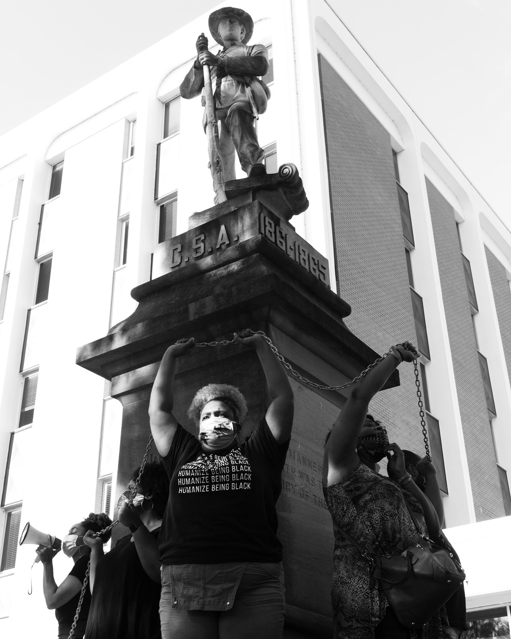 Protesters draped themselves in chains around the monument and sang spirituals on July 23, 2020. The names of children sold at the courthouse were also read.