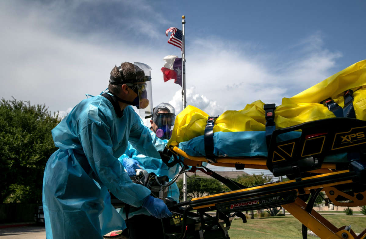Medics with Austin-Travis County EMS transport a nursing home resident with coronavirus symptoms on August 3, 2020, in Austin, Texas.