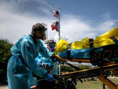 Medics with Austin-Travis County EMS transport a nursing home resident with coronavirus symptoms on August 3, 2020, in Austin, Texas.