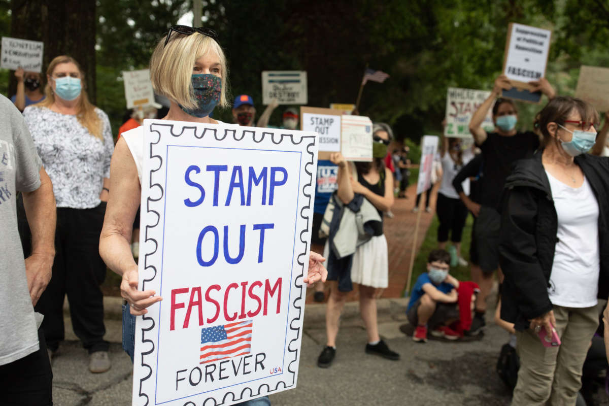 A group of protestors hold a demonstration in front of Postmaster General Louis DeJoy's home in Greensboro, North Carolina, on August 16, 2020.