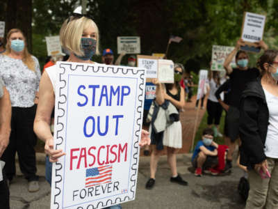 A group of protestors hold a demonstration in front of Postmaster General Louis DeJoy's home in Greensboro, North Carolina, on August 16, 2020.