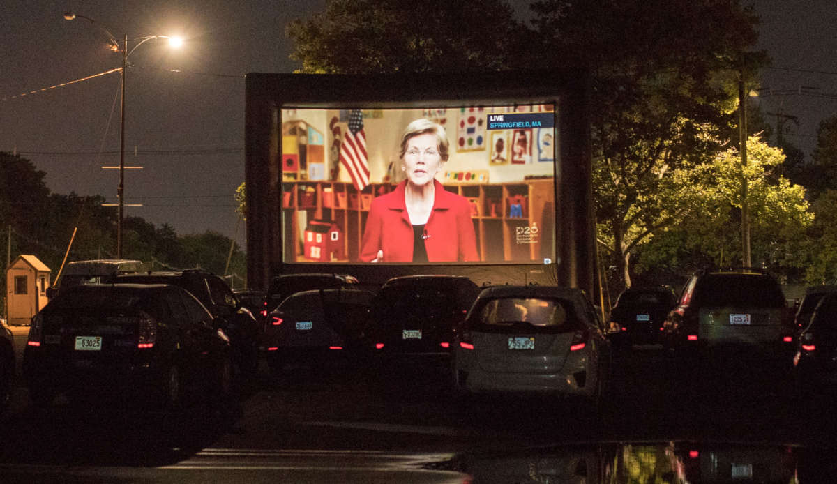 A screen projects Sen. Elizabeth Warren during a drive-in watch party for the virtual Democratic National Convention hosted by the Massachusetts Democrats at Suffolk Downs on August 19, 2020, in Boston, Massachusetts.