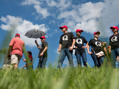 Supporters of President Donald Trump wearing 'QAnon' t-shirts wait in line before a campaign rally at Freedom Hall on October 1, 2018, in Johnson City, Tennessee.