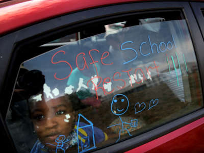 A Boston Public School student prepares for a caravan protest in Boston, Massachusetts, on August 13, 2020.