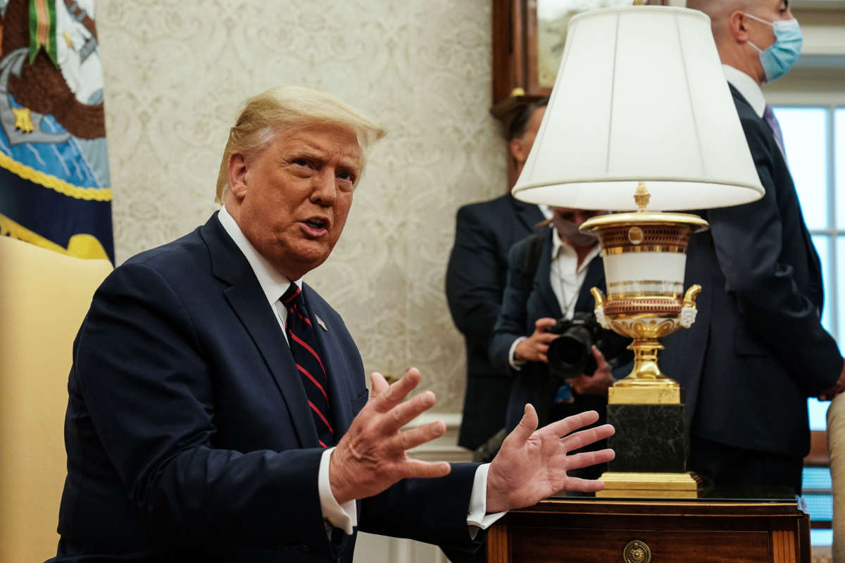 President Trump talks to reporters during a meeting in the Oval Office at the White House, August 20, 2020, in Washington, D.C.