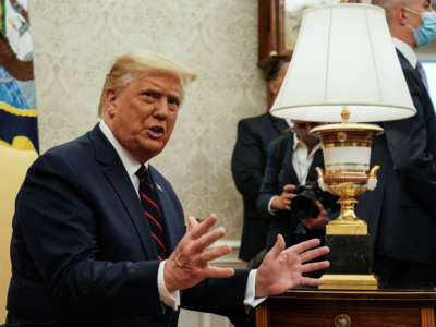 President Trump talks to reporters during a meeting in the Oval Office at the White House, August 20, 2020, in Washington, D.C.