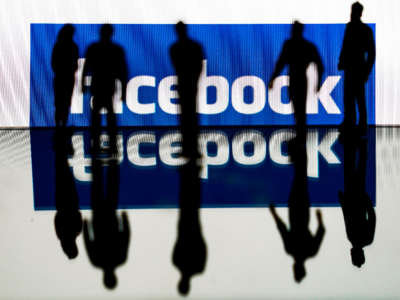 Silhouettes over Facebook logo