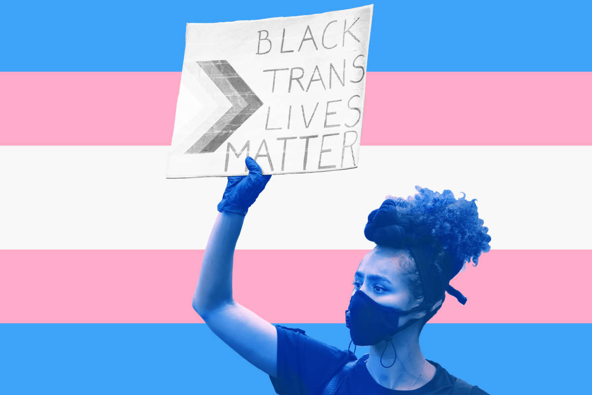 A woman holds a sign reading "black trans lives matter" in front of a graphic of the trans flag