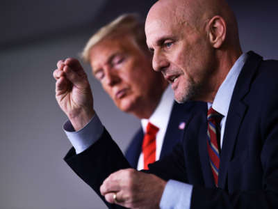 President Trump listens to FDA Commissioner Stephen Hahn speak on the latest developments of the COVID-19 outbreak in the James Brady Press Briefing Room at the White House, March 19, 2020, in Washington, D.C.