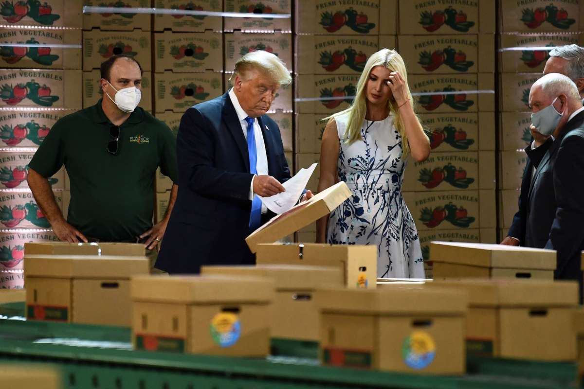 Trump and his daughter look at a clipboard