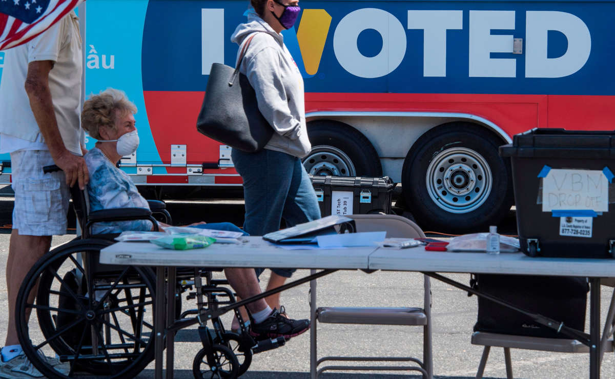 People wait to cast their votes at a polling station in Santa Clarita, California, on May 12, 2020.