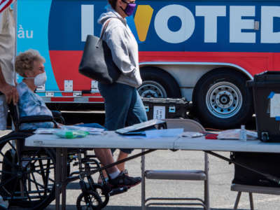 People wait to cast their votes at a polling station in Santa Clarita, California, on May 12, 2020.