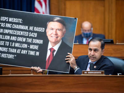 Representative Raja Krishnamoorthi holds a picture referencing Robert Duncan, chairman of the USPS Service Board of Governors, during a hearing before the House Oversight and Reform Committee on August 24, 2020, on Capitol Hill in Washington, D.C.