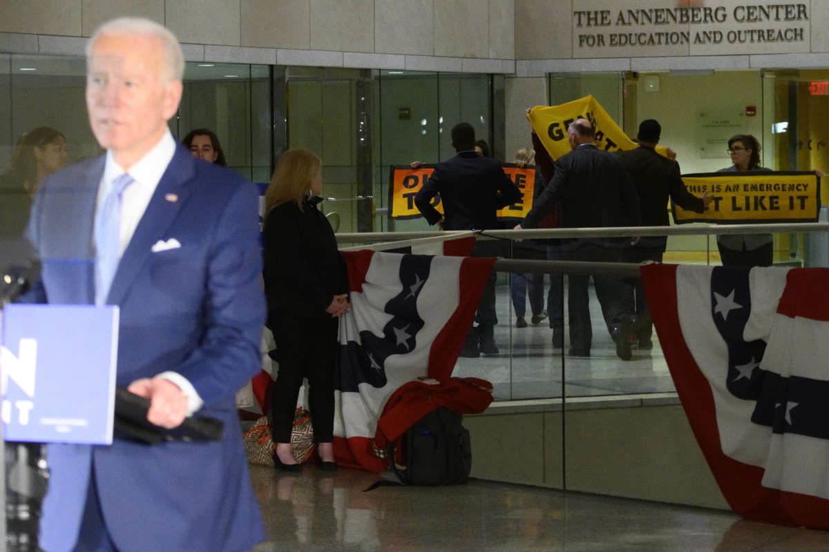 Climate activists briefly protest as former Vice President Joe Biden delivers remarks at the National Constitution Center in Philadelphia, Pennsylvania, on March 10, 2020.