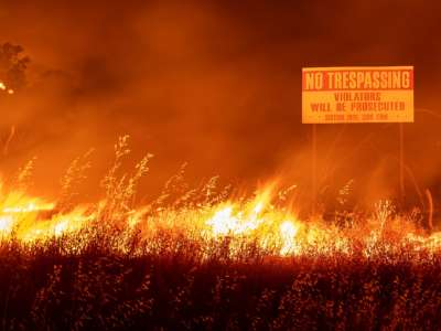 Flames race through a field in Winters, California, on August 19, 2020.