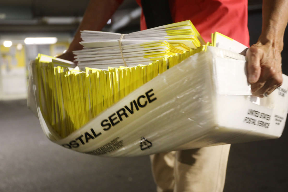 A polling worker holds 2020 presidential primary ballots that were dropped at a post office and brought to a government center to be processed and counted at the Stamford Government Center on August 11, 2020, in Stamford, Connecticut.
