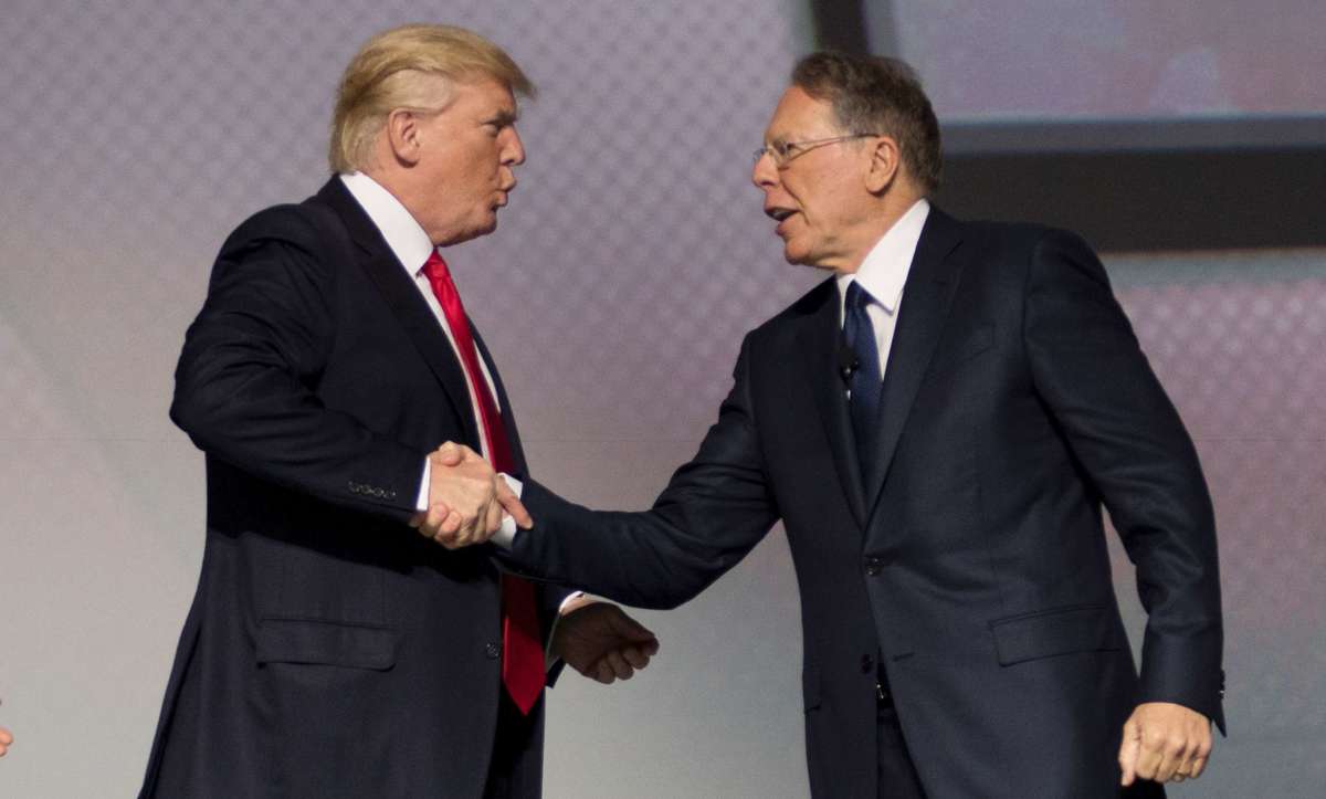 Donald Trump shakes hands with National Rifle Association (NRA) President Wayne LaPierre during the NRA Leadership Forum in Atlanta, Georgia, on April 28, 2017.c